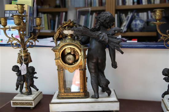 An early 20th century French bronzed spelter, ormolu and white marble clock garniture, 21.5in.
